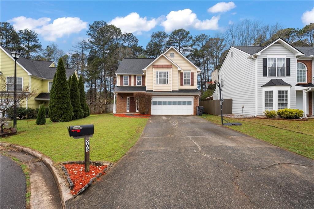 905 Ahearn Court Suwanee, GA 30024 - Photo 2 of 26 a front view of a house with garden