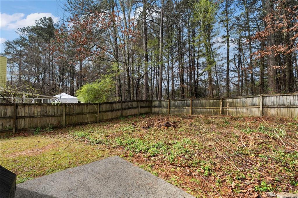 905 Ahearn Court Suwanee, GA 30024 - Photo 25 of 26 a view of a yard with wooden fence