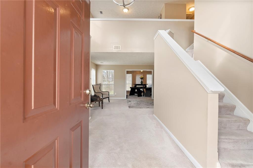 905 Ahearn Court Suwanee, GA 30024 - Photo 3 of 26 a view of a livingroom with furniture and entryway
