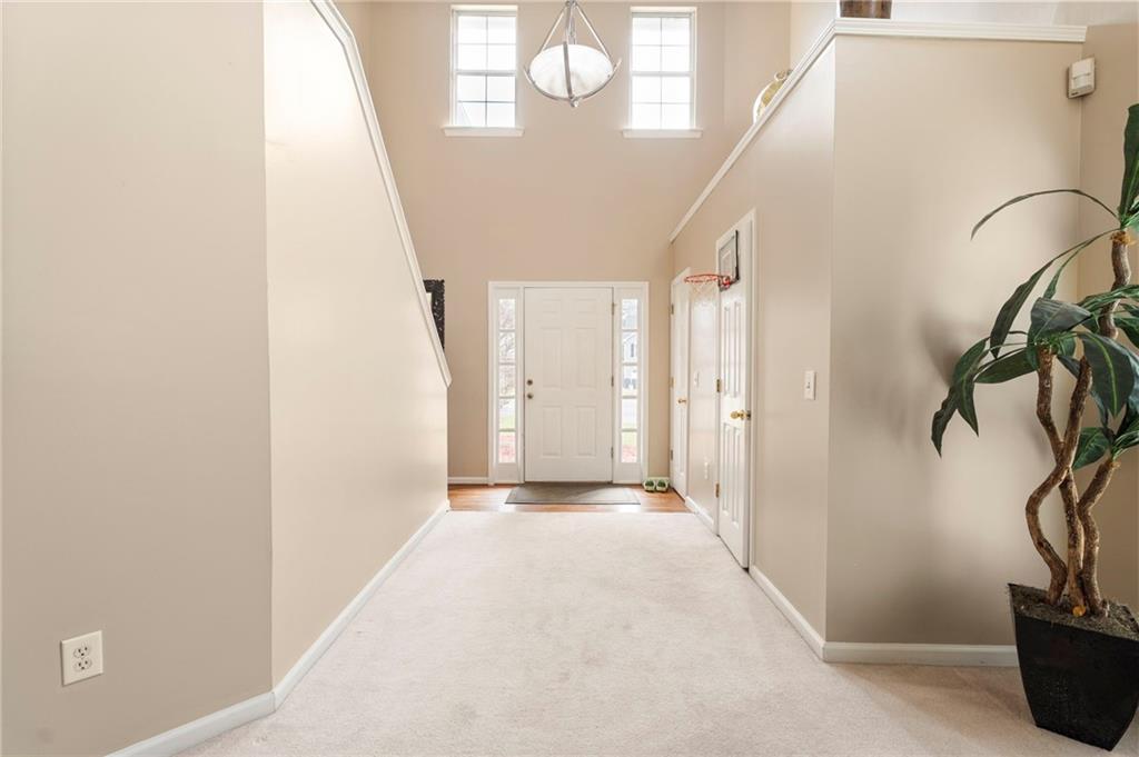 905 Ahearn Court Suwanee, GA 30024 - Photo 4 of 26 a view of a hallway with paintings on the wall