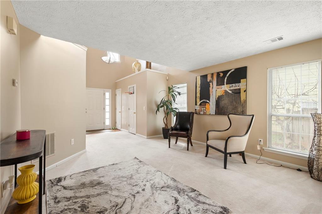 905 Ahearn Court Suwanee, GA 30024 - Photo 5 of 26 a living room with furniture and a window