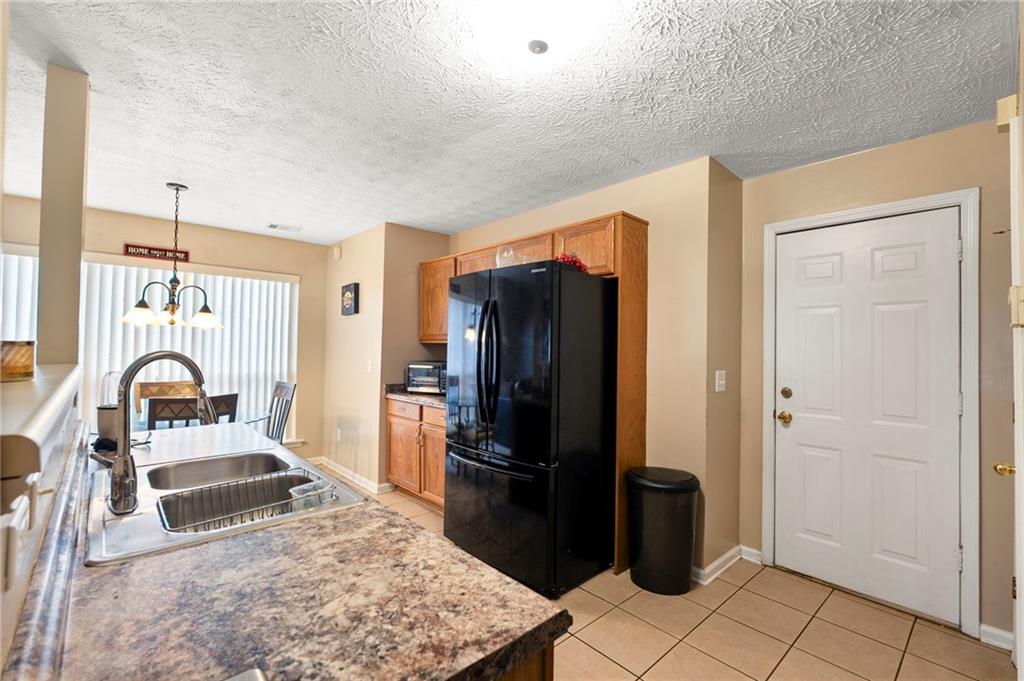 905 Ahearn Court Suwanee, GA 30024 - Photo 9 of 26 a kitchen with stainless steel appliances granite countertop a refrigerator and a sink