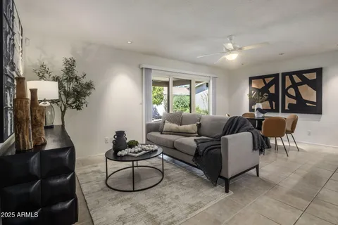 a living room with furniture and a lamp