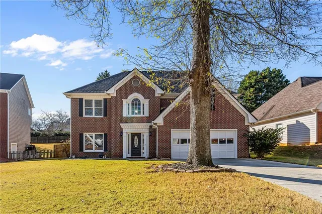 a front view of a house with a yard