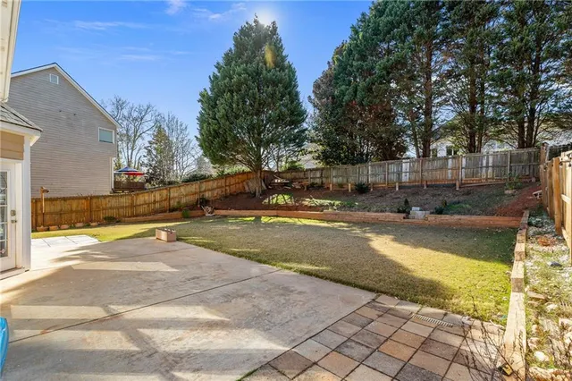 a view of backyard with large trees