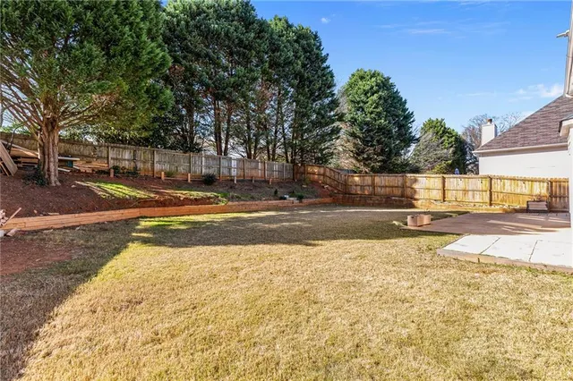 a view of yard with swimming pool and trees