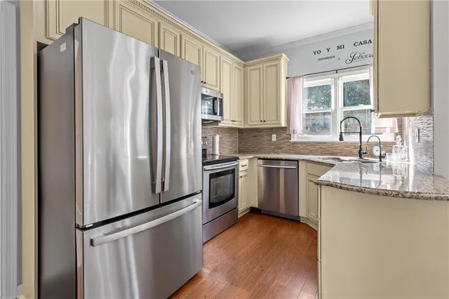 a kitchen with stainless steel appliances a refrigerator sink and cabinets