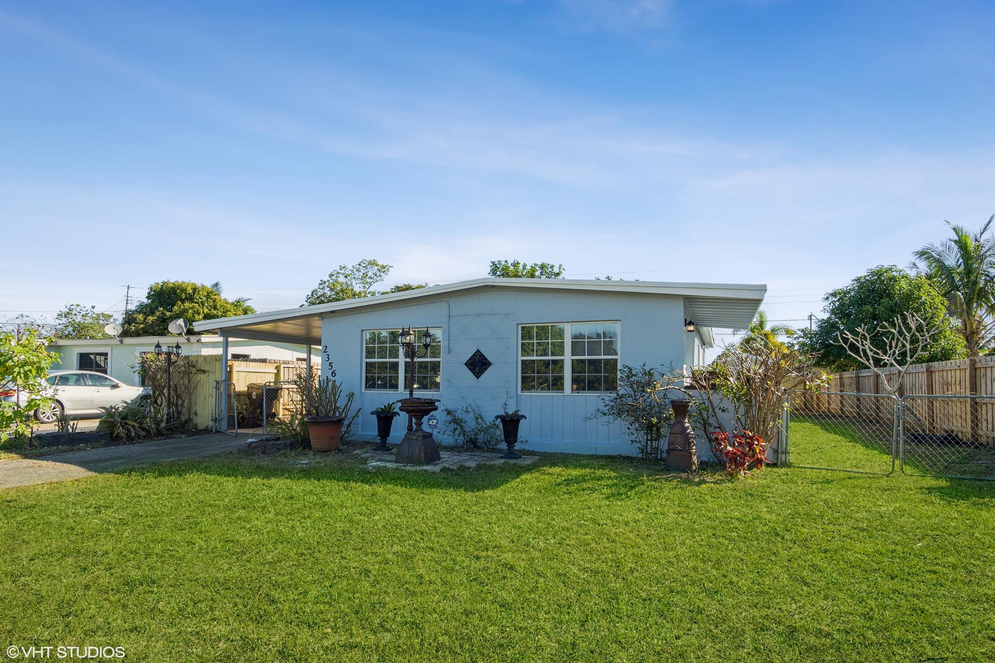 2356 Rue Road West Palm Beach, FL 33415 - Photo 5 of 26 05_2356RueRoad_574_FrontView_HiRes