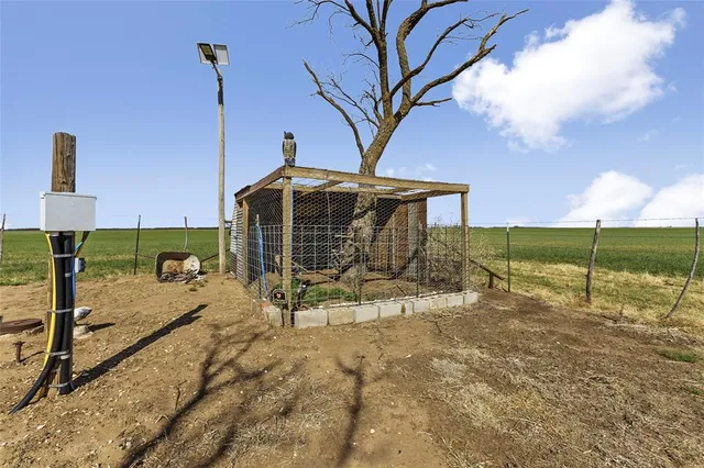 a view of yard covered with snow in front of door