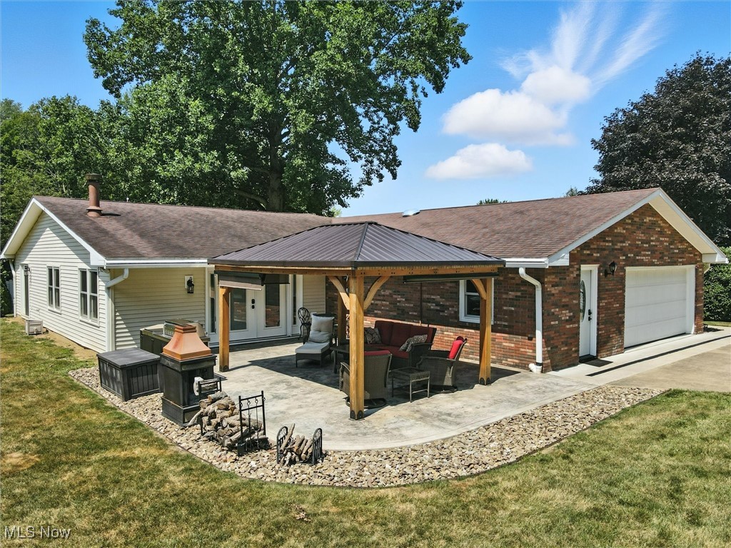 2930 South Ridge Road East Kingsville, OH 44048 - Photo 45 of 49 Rear view of property with an outdoor living space, brick siding, a yard, driveway, and a patio