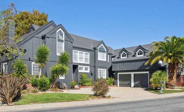 a front view of house with yard and green space