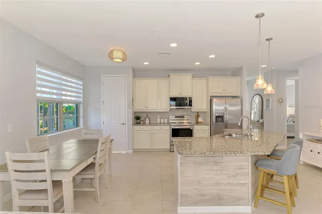 a dining room with furniture and a large window