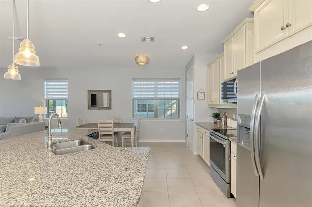 a living room with furniture and a view of kitchen