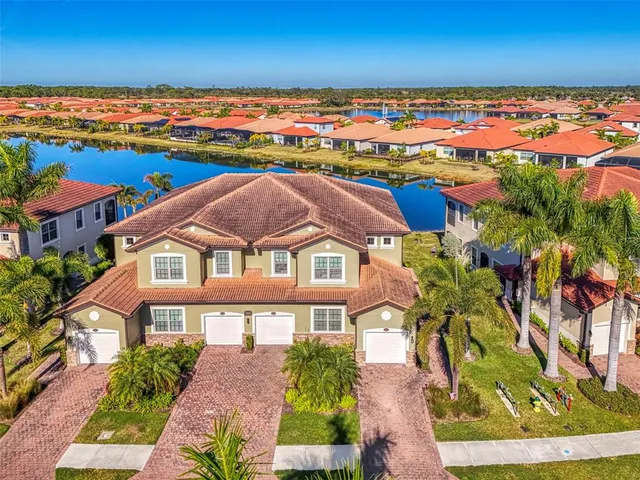 an aerial view of a house with a lake view