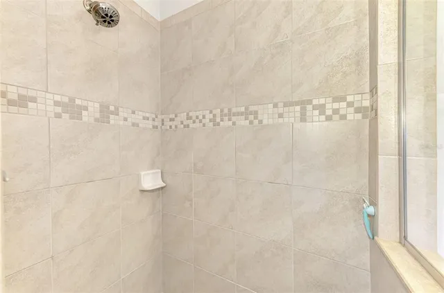 a view of a house with swimming pool lawn chairs and a yard