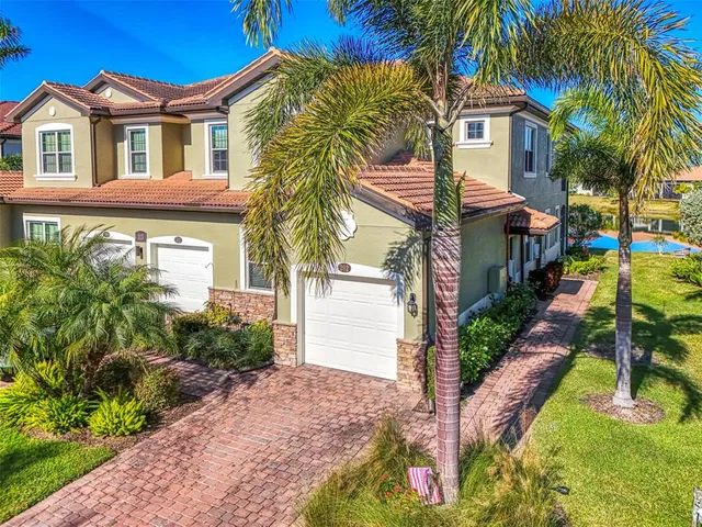 a kitchen with stainless steel appliances granite countertop a kitchen island a stove a table and chairs