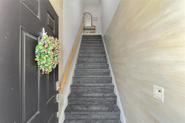 a kitchen with stainless steel appliances kitchen island granite countertop a table chairs and a refrigerator