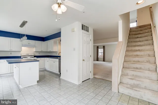 a kitchen with cabinets and window