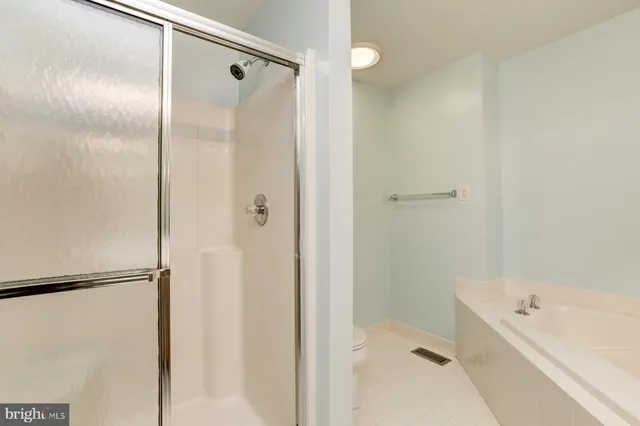 a bathroom with a bathtub and a shower