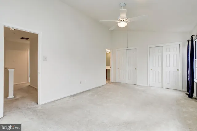 a view of an empty room with a ceiling fan