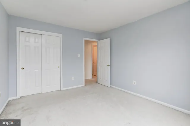 a view of an empty room and closet area