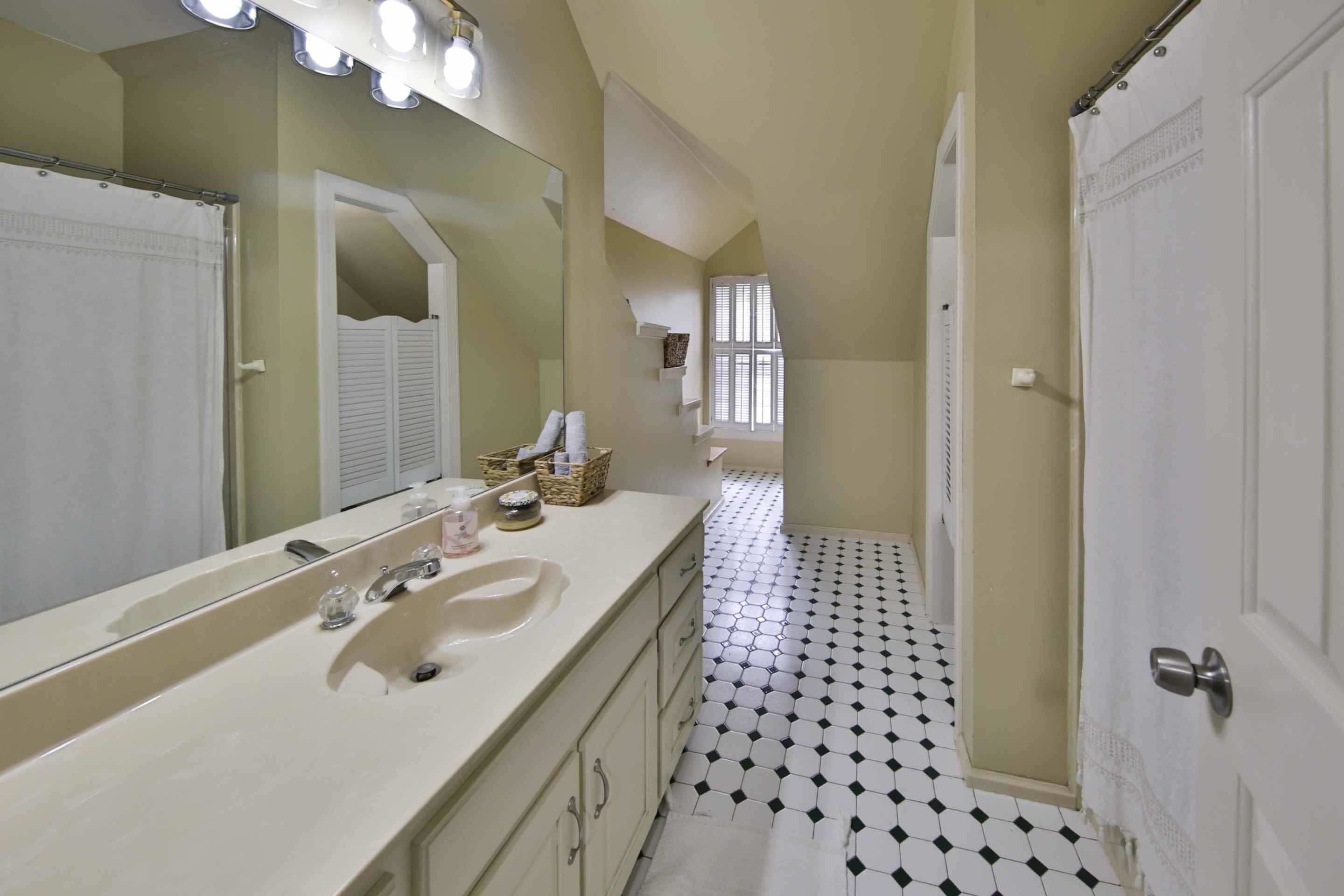 104 Miller Road Covington, TN 38019 - Photo 25 of 25 Bathroom vanity with an integrated sink, polished chrome faucet, and a large wall-mounted mirror