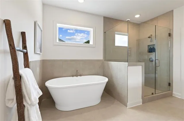 a white tub sitting next to a bathroom