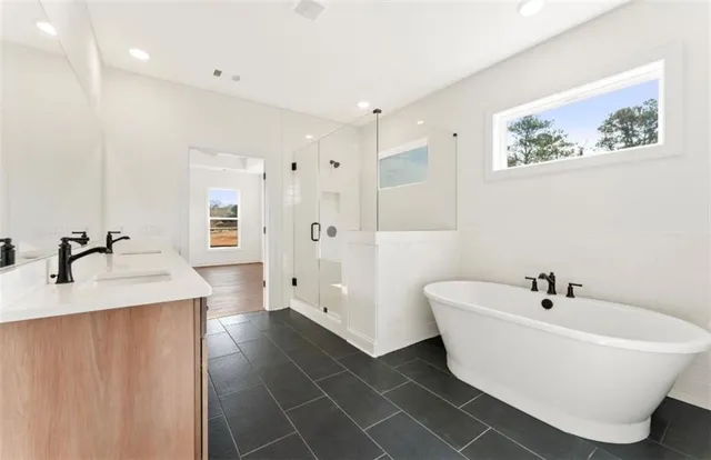 a white bath tub sitting next to a bathroom sink
