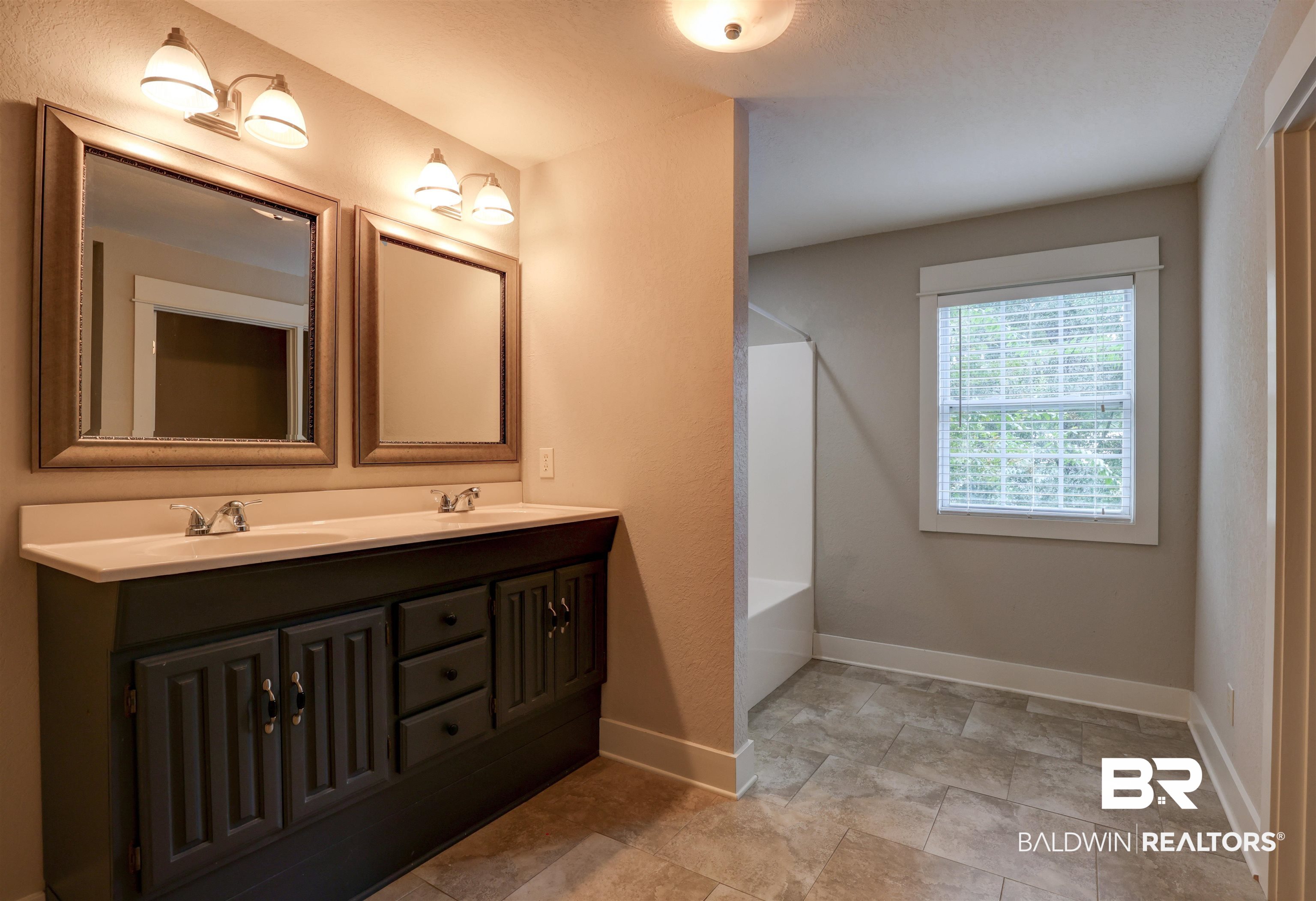 2079 Alabama Street Loxley, AL 36551 - Photo 24 of 42 Bathroom featuring tile patterned flooring and dual bowl vanity