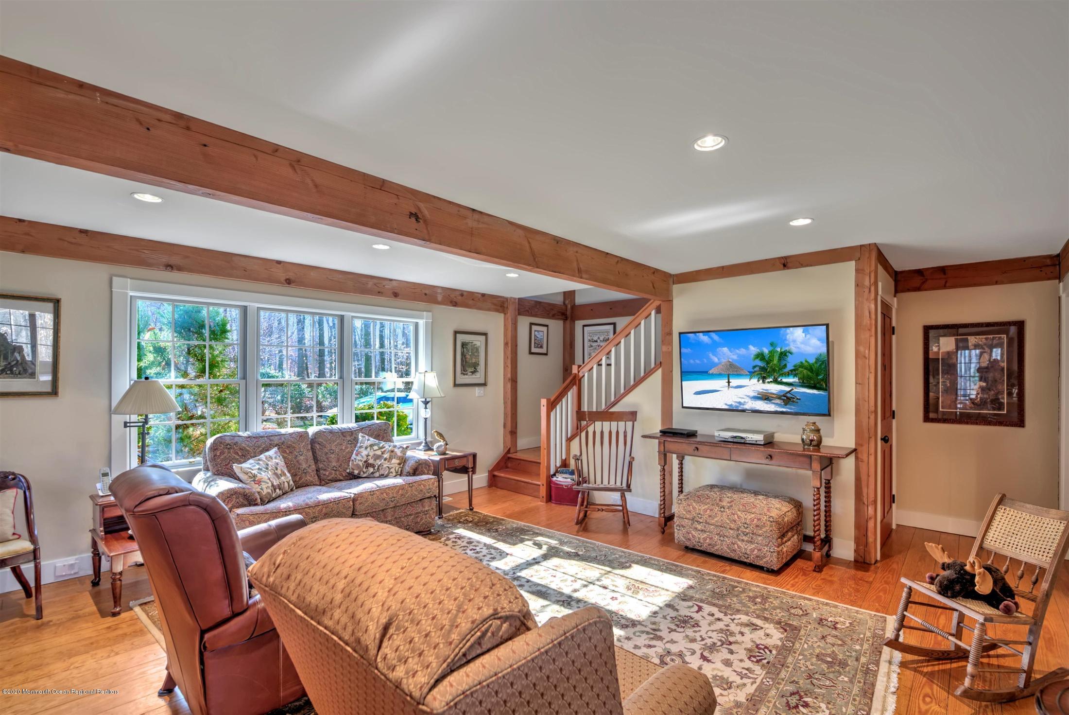 886 Province Line Road Allentown, NJ 08501 - Photo 14 of 56 a living room with furniture a flat screen tv and a floor to ceiling window