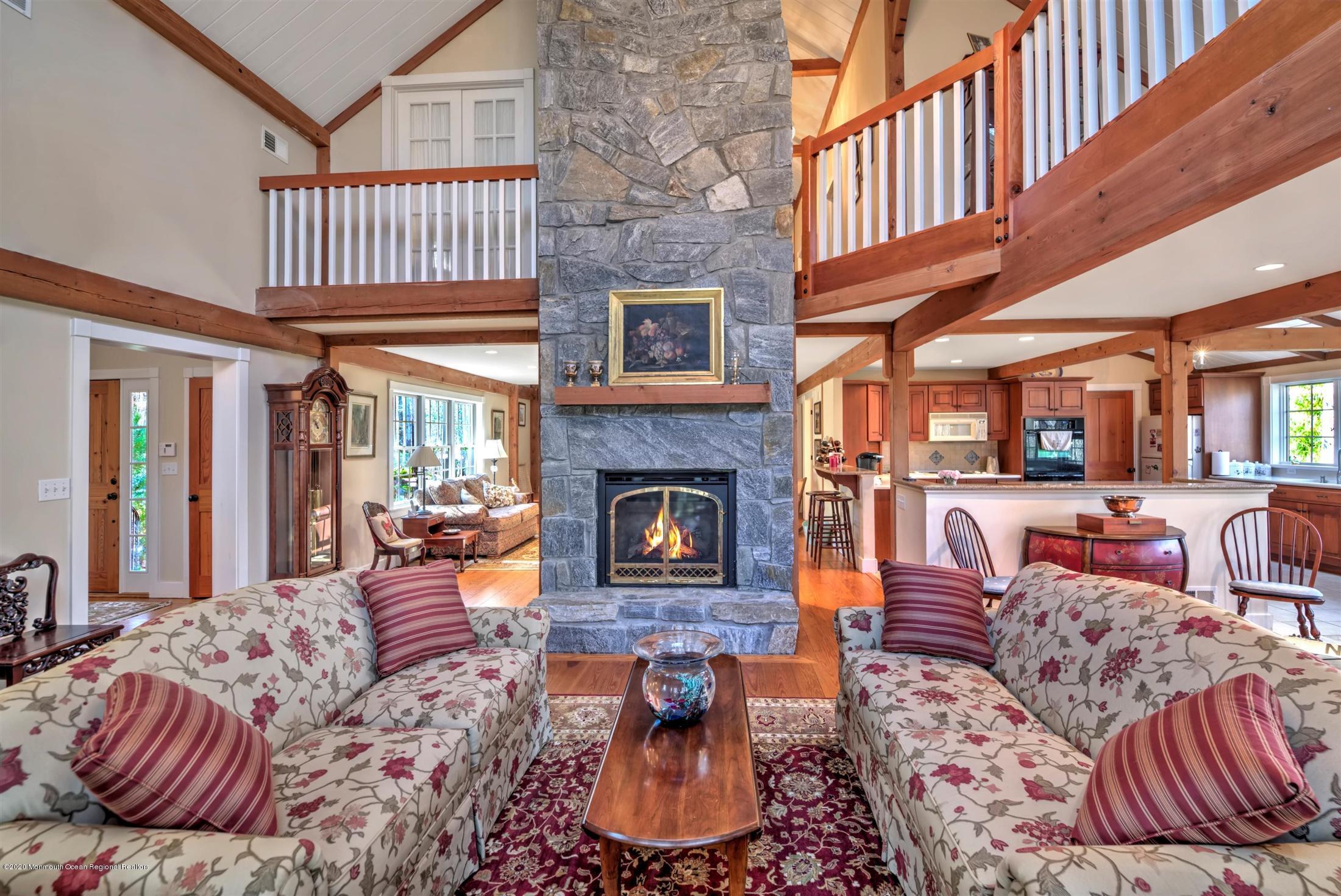 886 Province Line Road Allentown, NJ 08501 - Photo 6 of 56 a living room with furniture a fireplace and a floor to ceiling window