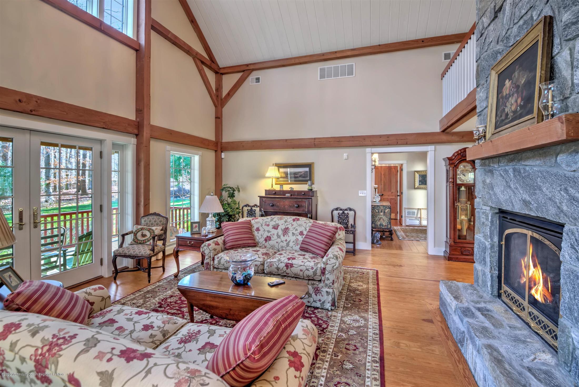 886 Province Line Road Allentown, NJ 08501 - Photo 10 of 56 a living room with furniture a fireplace and a floor to ceiling window