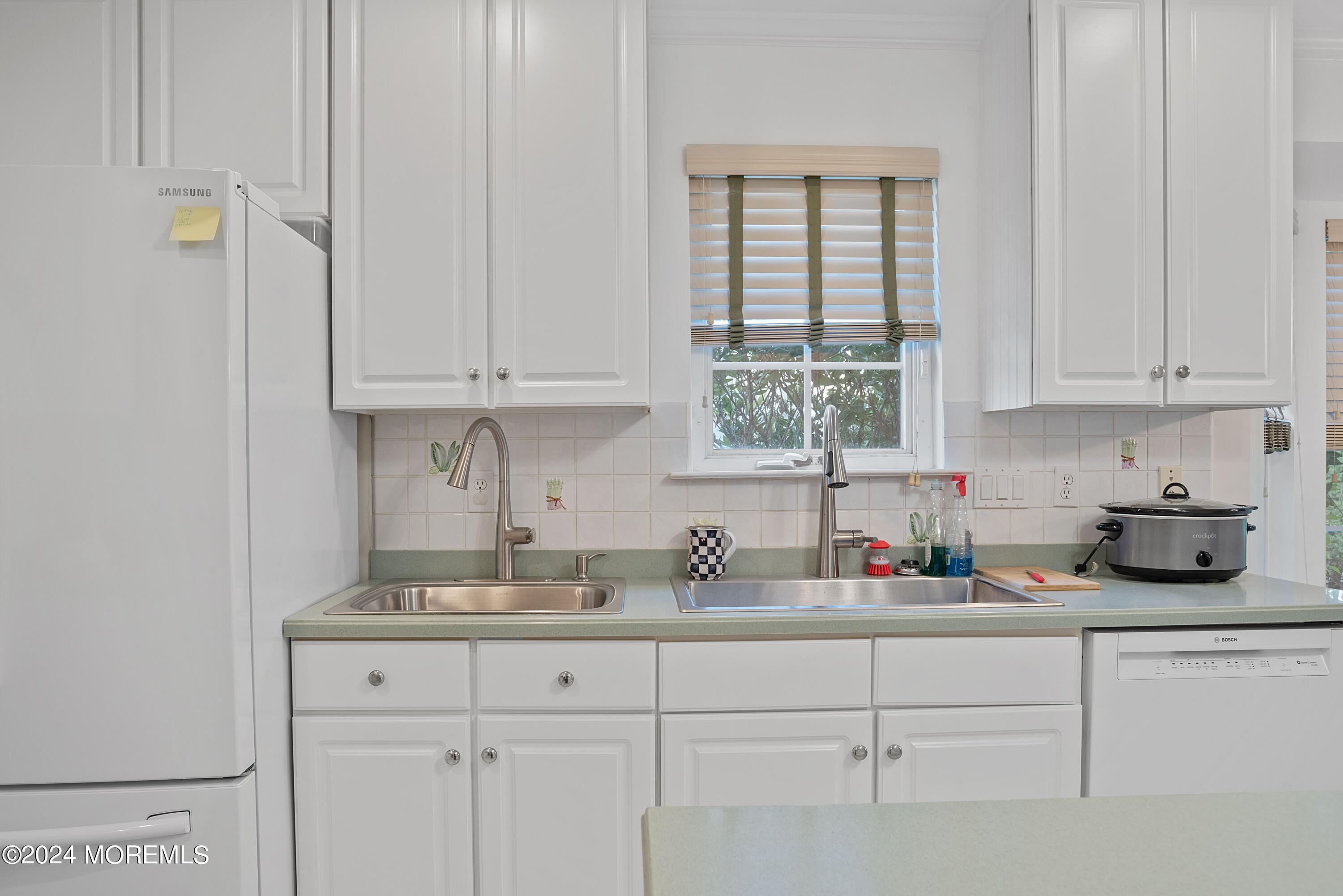 54 Foxwood Road Lakewood, NJ 08701 - Photo 28 of 45 a kitchen with white cabinets and a window