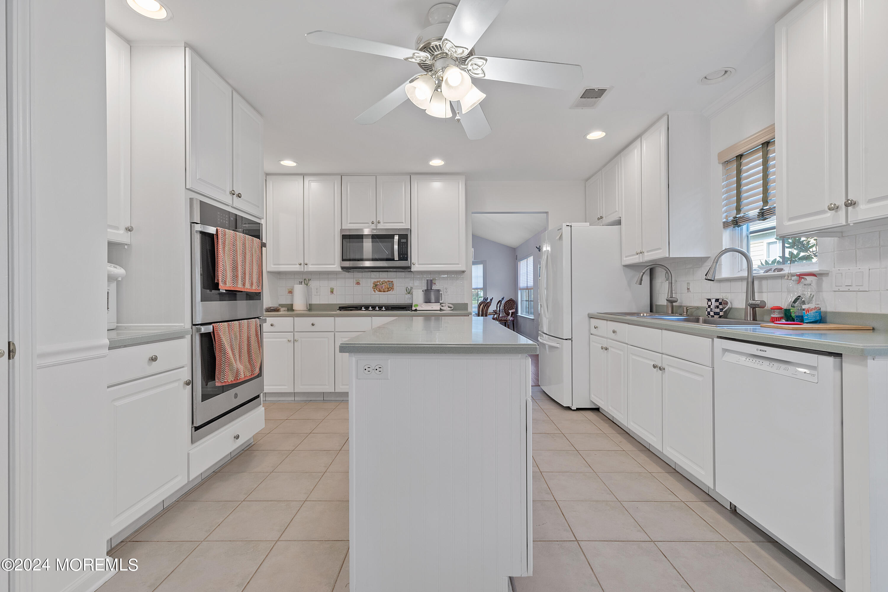 54 Foxwood Road Lakewood, NJ 08701 - Photo 3 of 45 a kitchen with white cabinets and stainless steel appliances