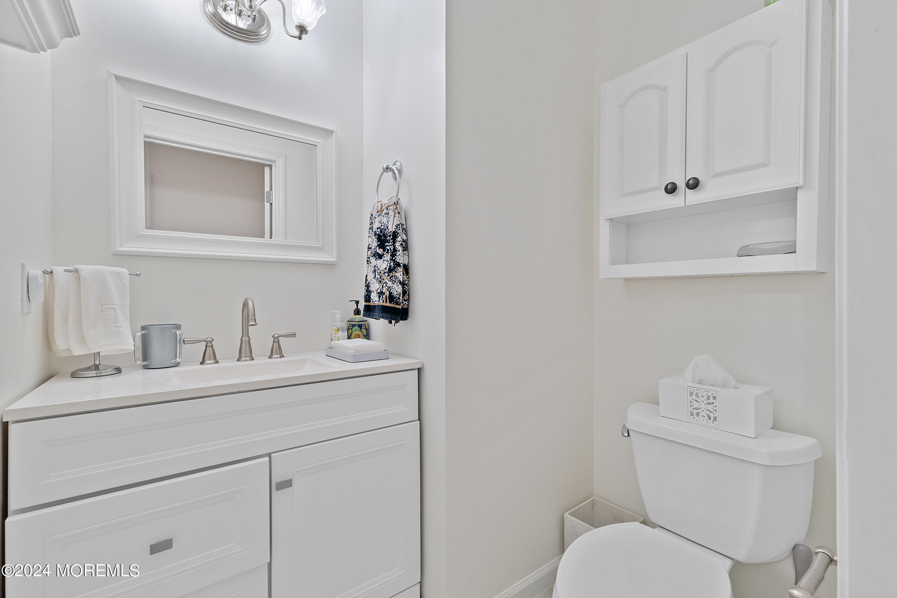 54 Foxwood Road Lakewood, NJ 08701 - Photo 31 of 45 a bathroom with a toilet sink vanity and mirror