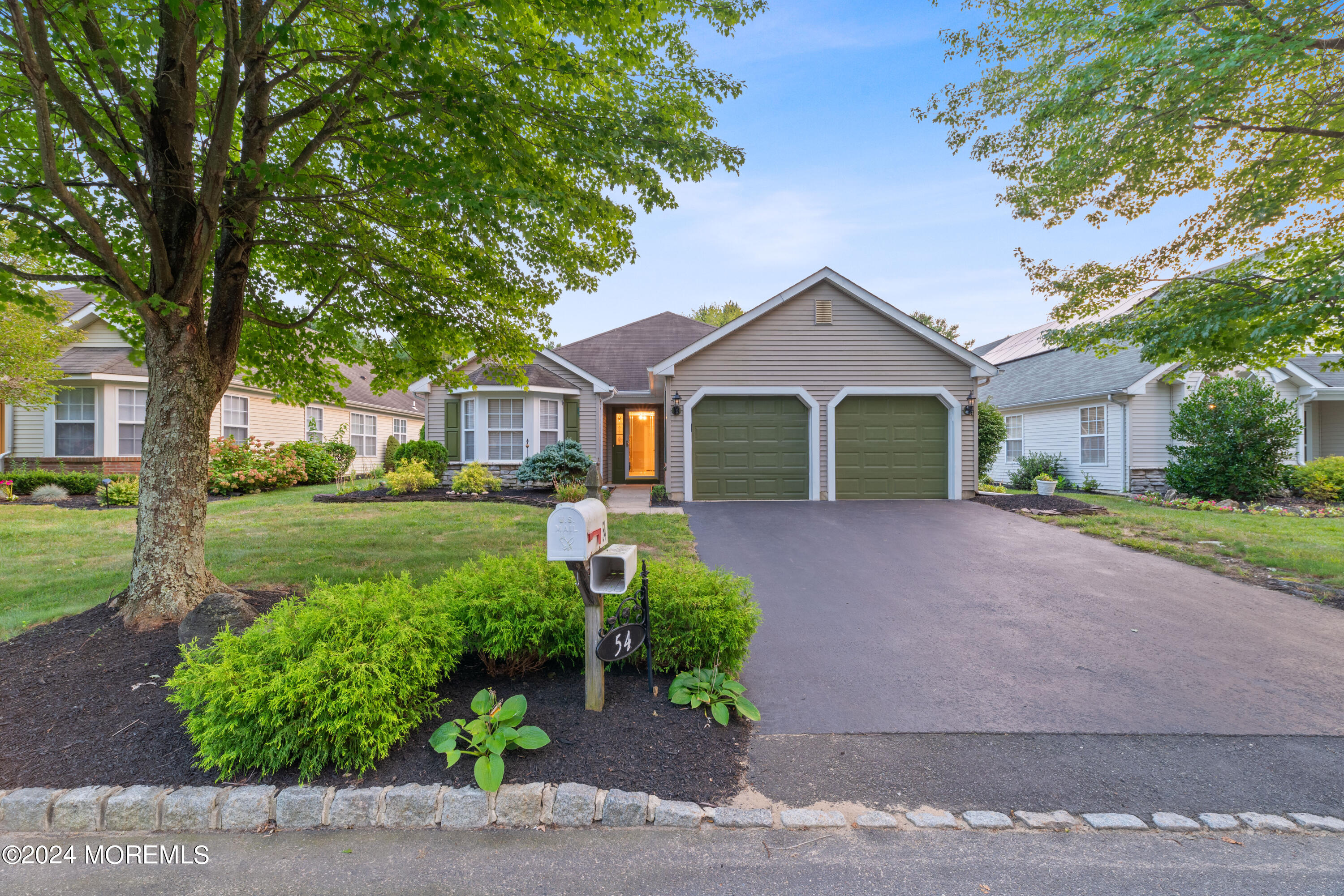 54 Foxwood Road Lakewood, NJ 08701 - Photo 33 of 45 a front view of a house with a yard and garage