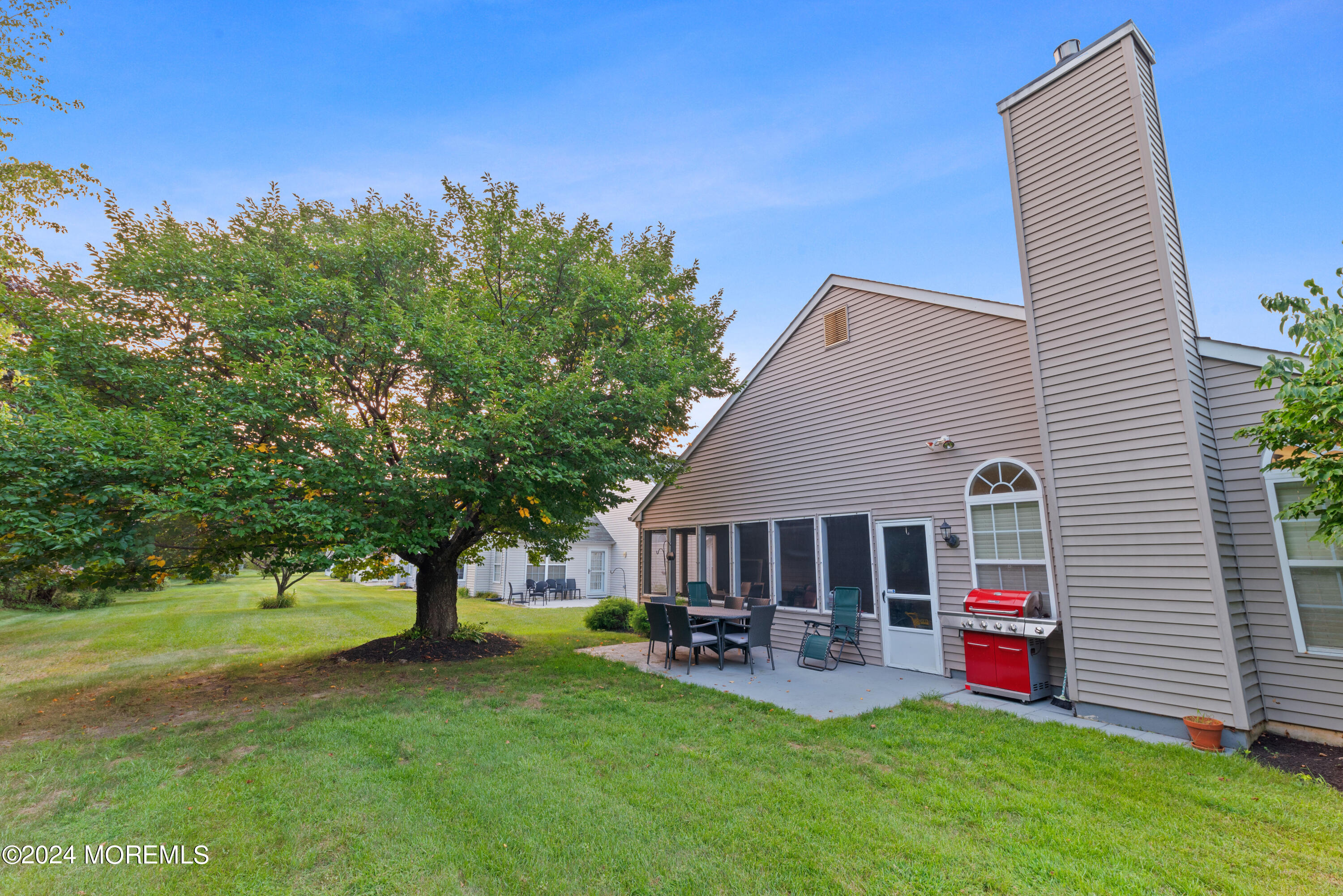 54 Foxwood Road Lakewood, NJ 08701 - Photo 37 of 45 a front view of a house with a garden and trees