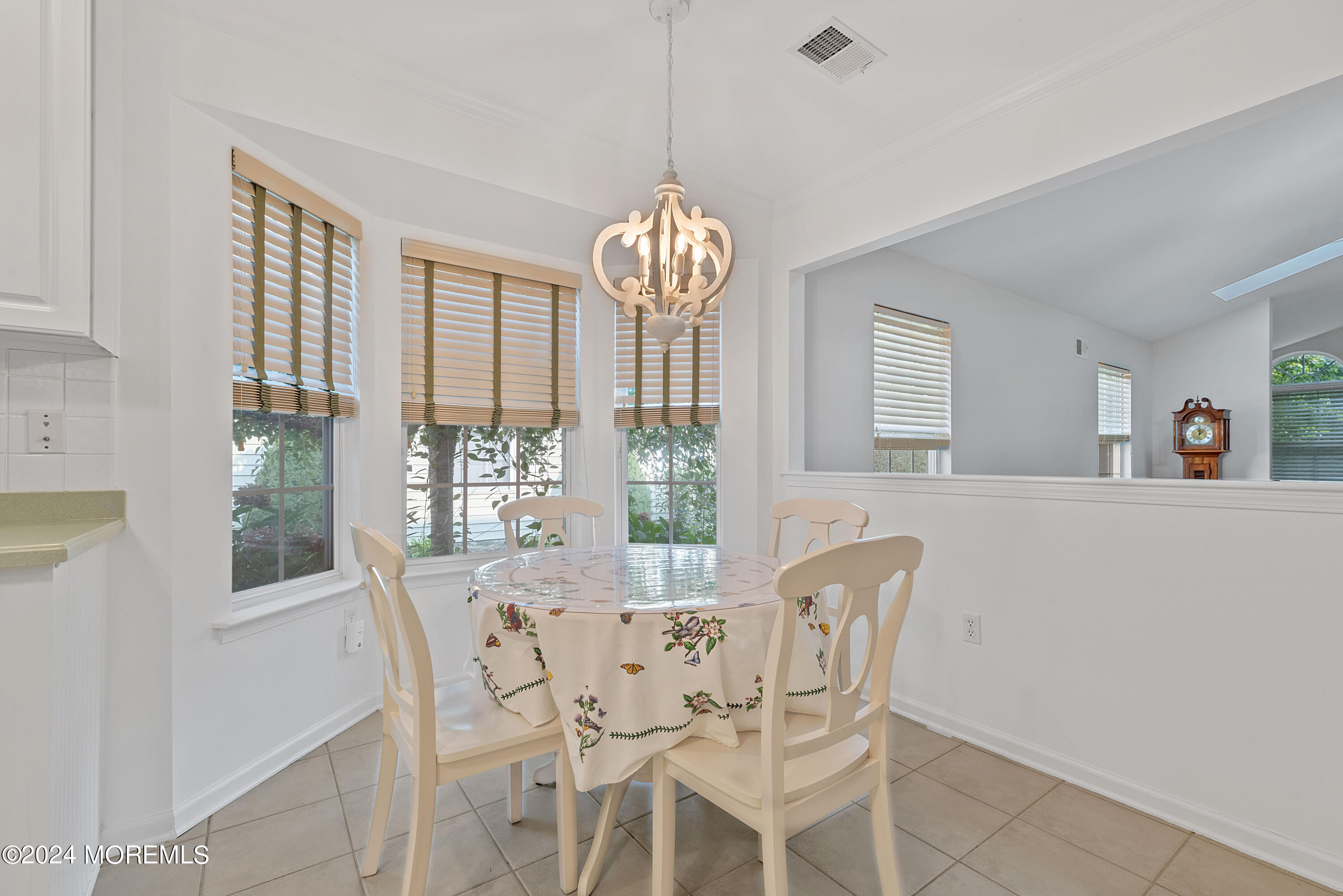 54 Foxwood Road Lakewood, NJ 08701 - Photo 5 of 45 a dining room with furniture a chandelier and wooden floor