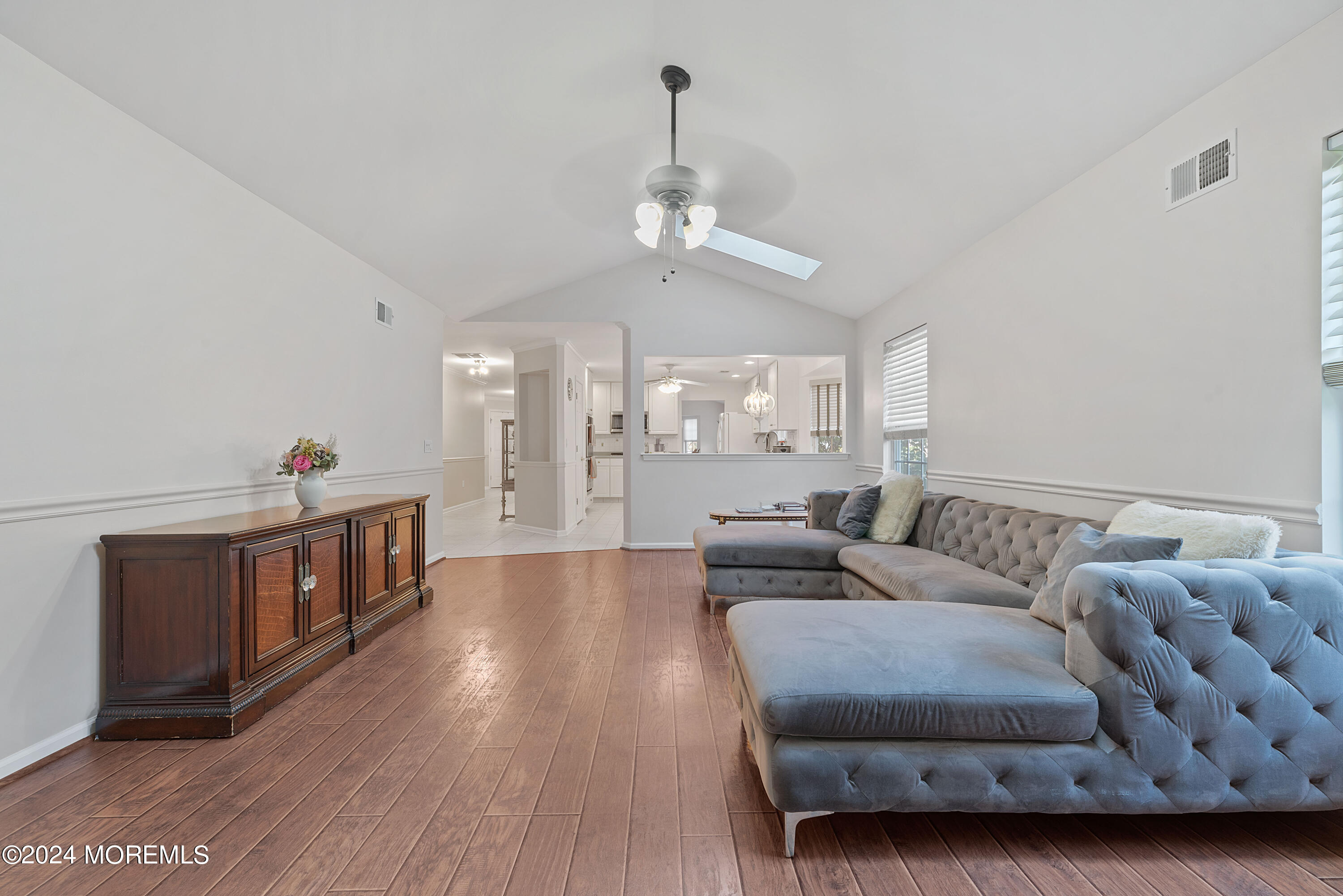 54 Foxwood Road Lakewood, NJ 08701 - Photo 9 of 45 a living room with furniture and a chandelier