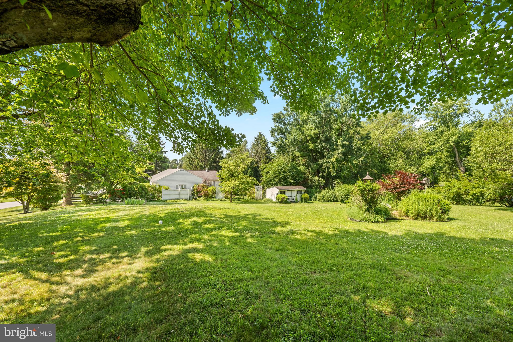 258 Monacy Road Coatesville, PA 19320 - Photo 15 of 54 a backyard of a house with a yard and large trees