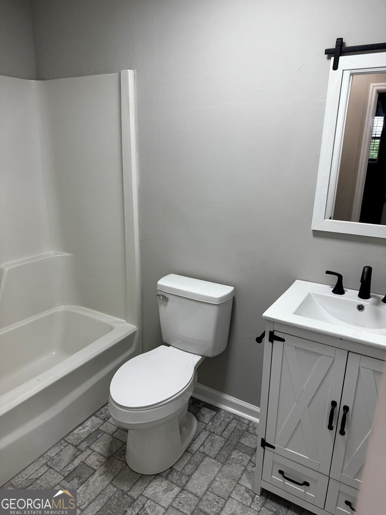 5781 Adams Road Valdosta, GA 31601 - Photo 17 of 27 a white toilet sitting next to a bathroom sink