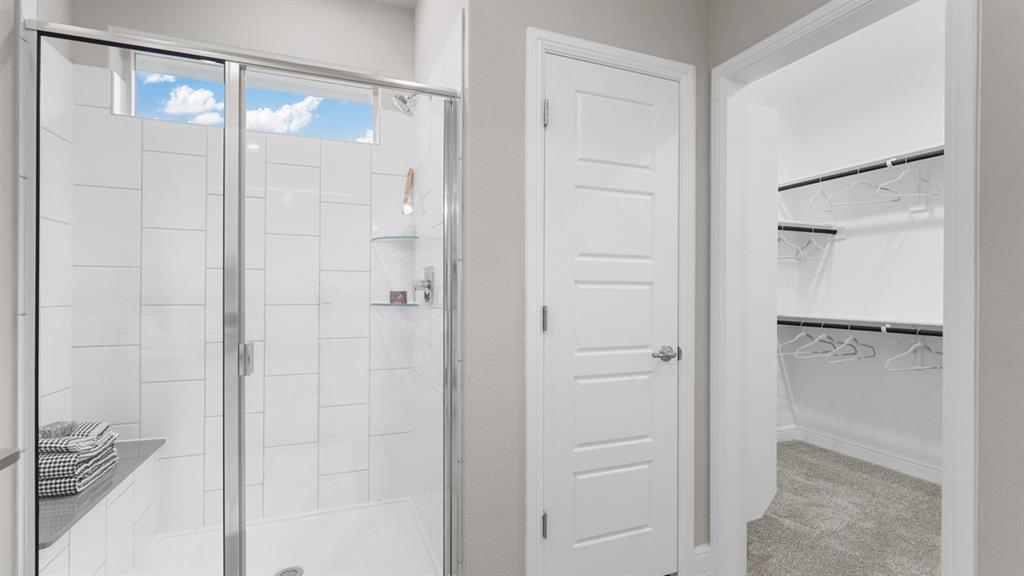 129 Hugo Court Rhome, TX 76078 - Photo 18 of 34 a bathroom with a glass shower door