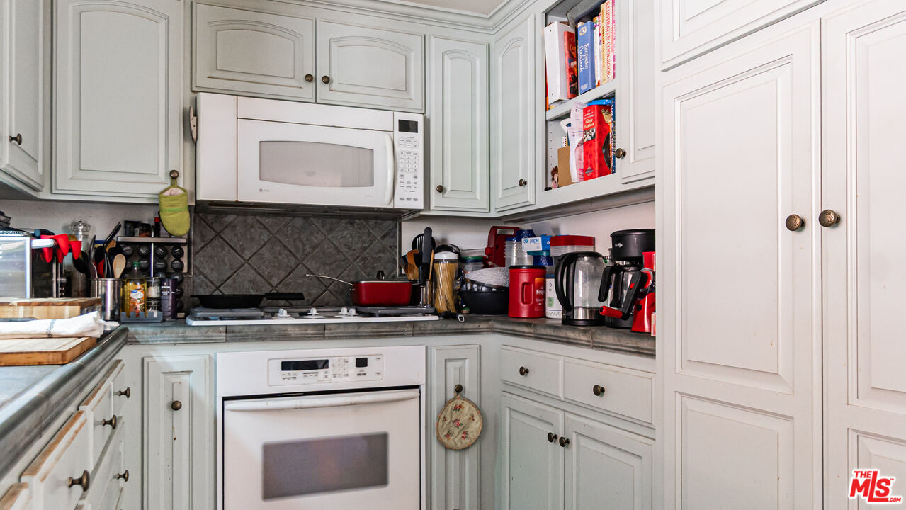 25843 Browning Place Stevenson Ranch, CA 91381 - Photo 16 of 37 a kitchen with white cabinets and white appliances