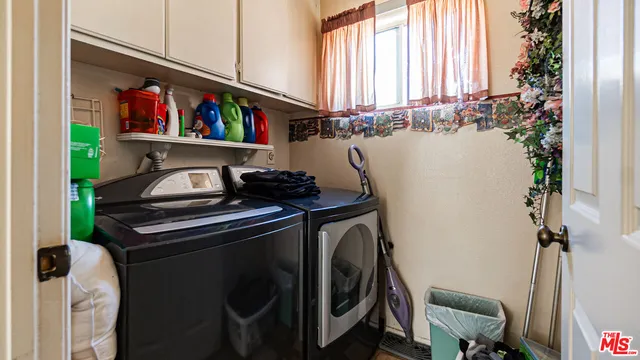 a view of a hallway with a livingroom and a bathroom with sink