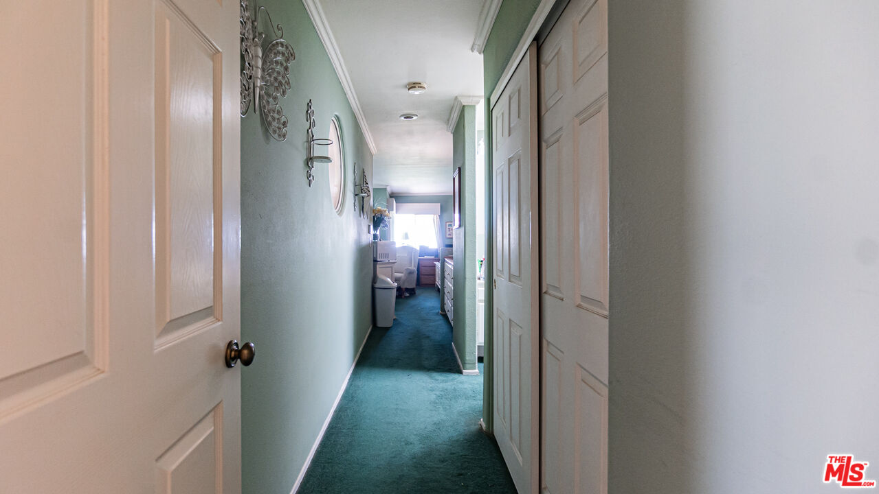 25843 Browning Place Stevenson Ranch, CA 91381 - Photo 22 of 37 a view of a hallway with a livingroom and a bathroom with sink