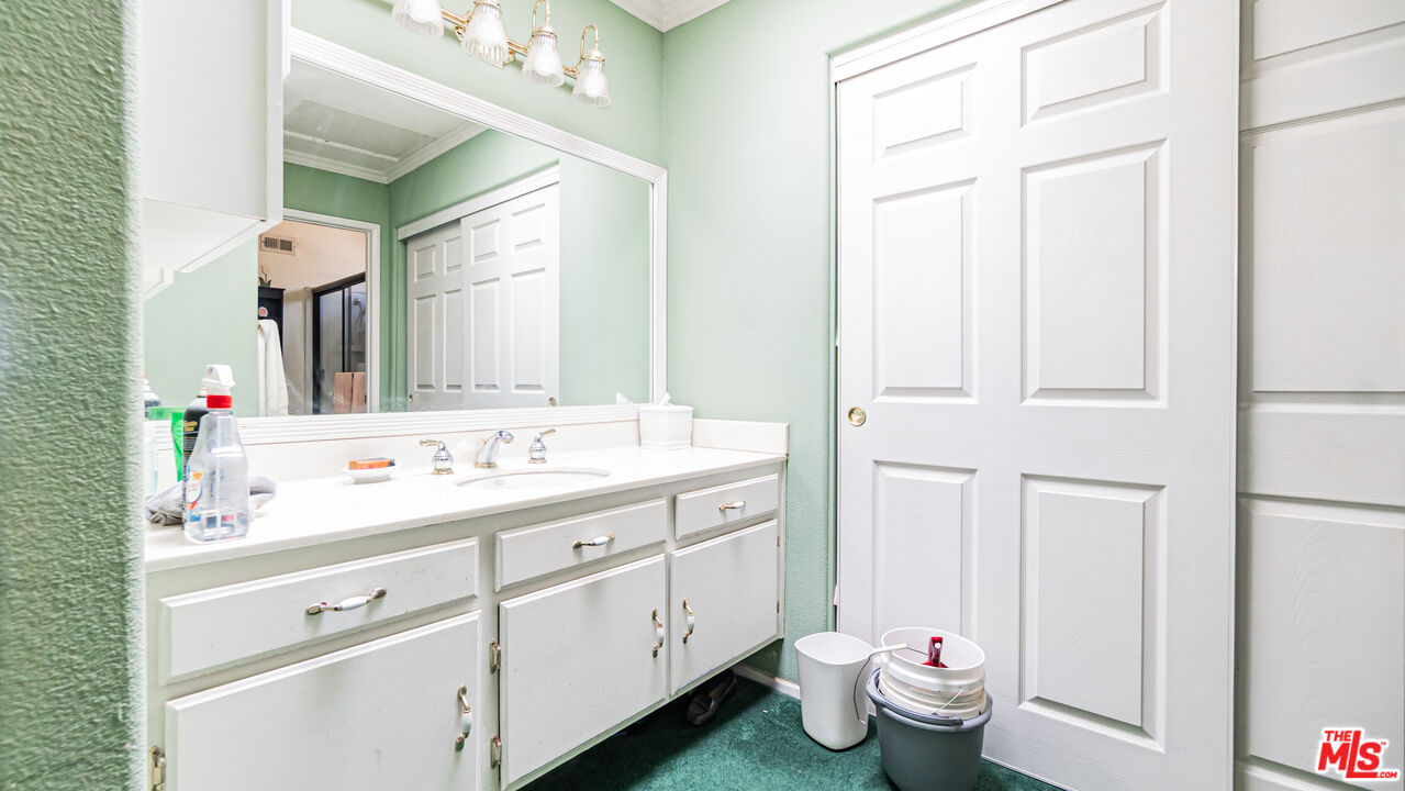 25843 Browning Place Stevenson Ranch, CA 91381 - Photo 23 of 37 a bathroom with a double vanity sink mirror and toilet