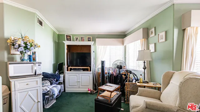 a room with furniture a flat screen tv and a table