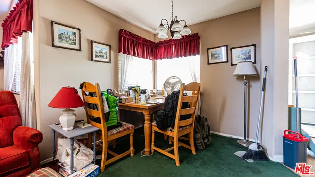 a view of a dining room with furniture and chandelier