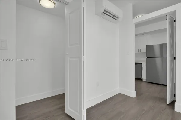 a view of empty room with wooden floor