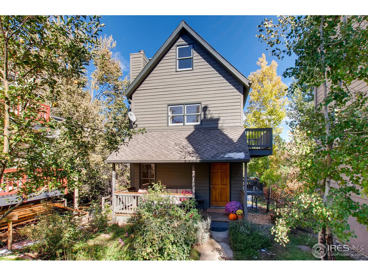 a view of a house with potted plants and a tree